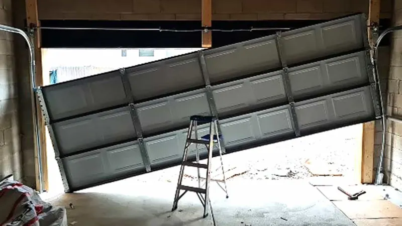 Garage door hanging crooked after coming off its tracks
