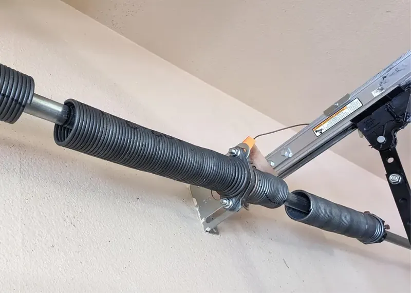 Snapped garage door torsion spring on the shaft above the door